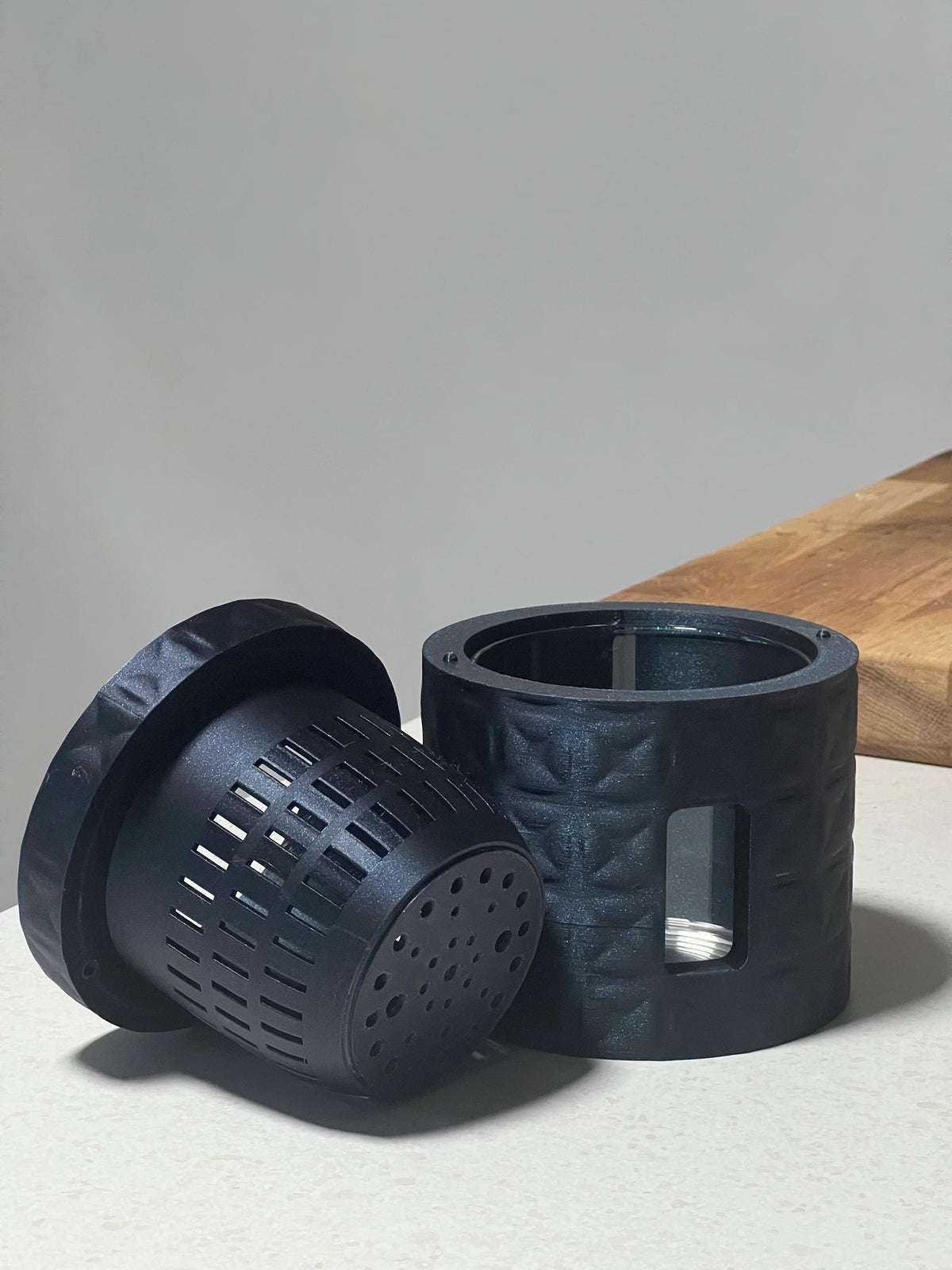 Dara self-watering semi-hydroponic planter in sparkly midnight filament showing inner plant medium basket.