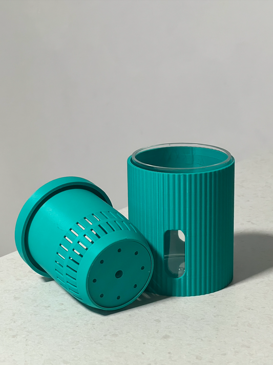 Edené Micro self-watering plant pot in Bright Teal shown with removable acrylic liner, illustrating the self-watering reservoir system